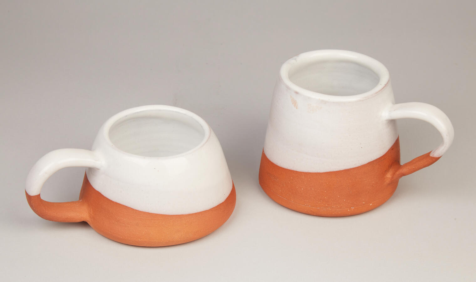 "Glazed Donut Mugs," 2021. Two wheel-thrown, red clay mugs, 7.5 x 5.5 x 4 inches and 6.5 x 5 x 5.5 inches, $25 each.
