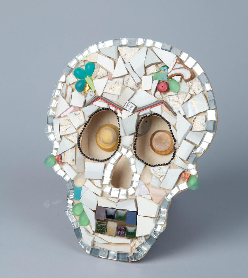 "Mask," 2017. Mixed media Sculpture: Ceramic, glass, mirror shards, buttons, ceramic tiles, metal beaded chain, found wooden sculpture, 9 x 11 x 2 inches, $225.
